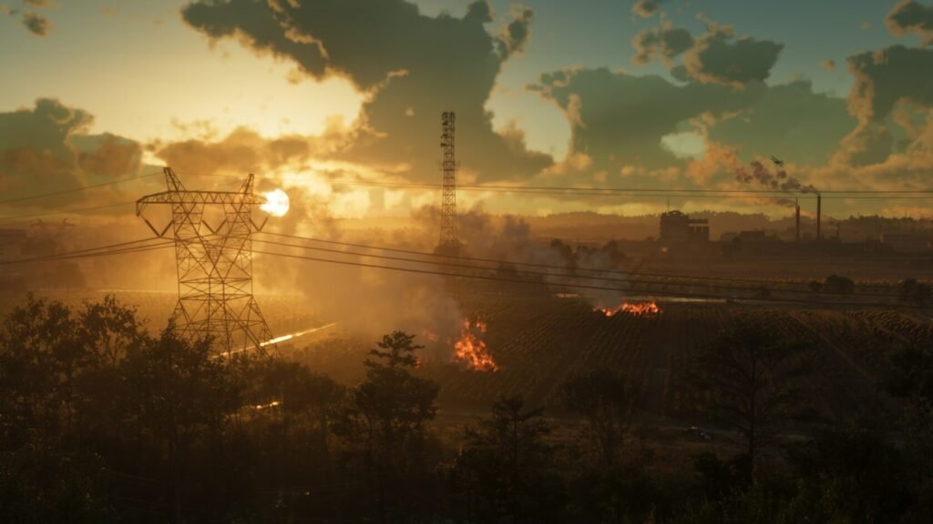 Линии электропередачи над горящим полем на закате