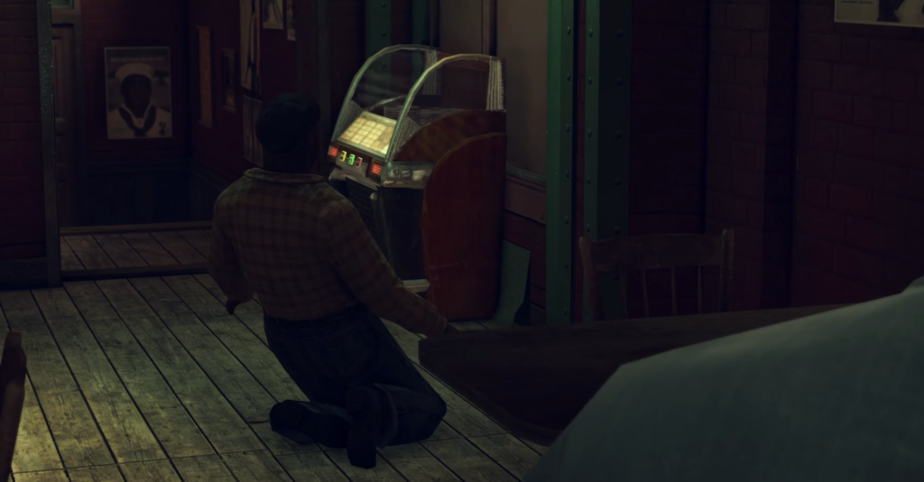 Мужчина на коленях у музыкального автомата в баре