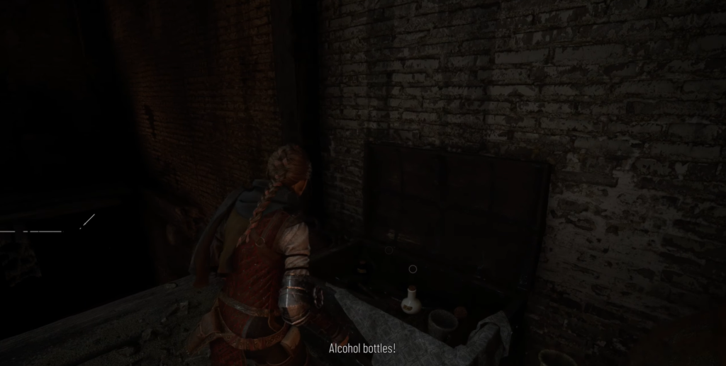 Амиция открывает сундук у кирпичной стены в A Plague Tale