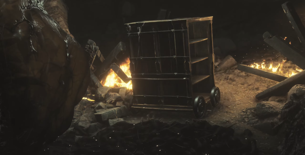 Черная тележка стоит среди огня и обломков