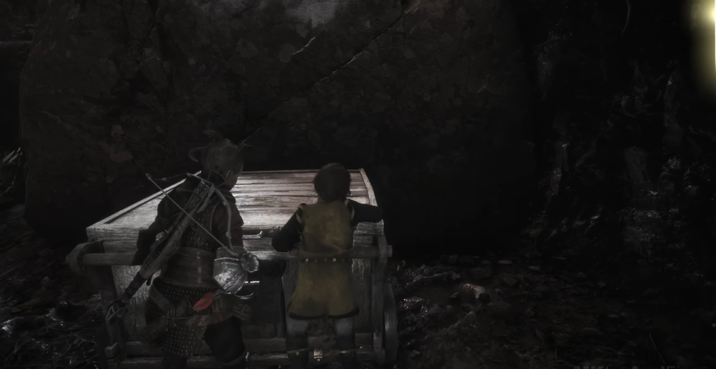 Амиция и Гуго толкают телегу в пещере A Plague Tale