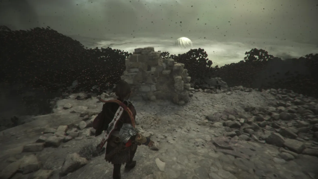 Персонаж идет по каменистой тропе к руинам